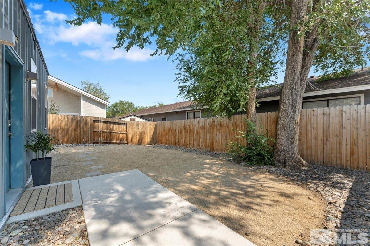1219 Lander Street Reno, NV 89509 - Photo 2 of 18 a view of backyard of house with wooden fence