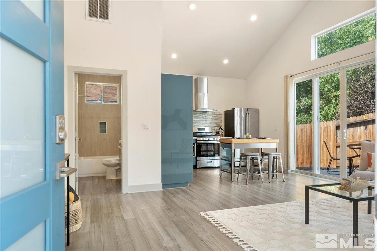 1219 Lander Street Reno, NV 89509 - Photo 7 of 18 a view of a dining room with furniture window and wooden floor