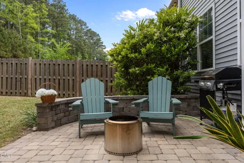 a view of a chairs and table in backyard