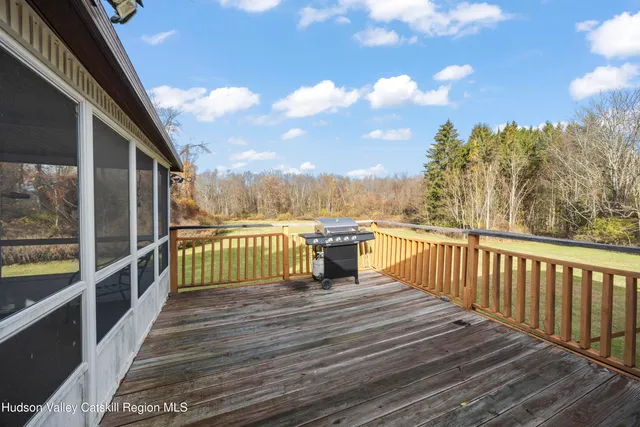 a view of a balcony with wooden floor