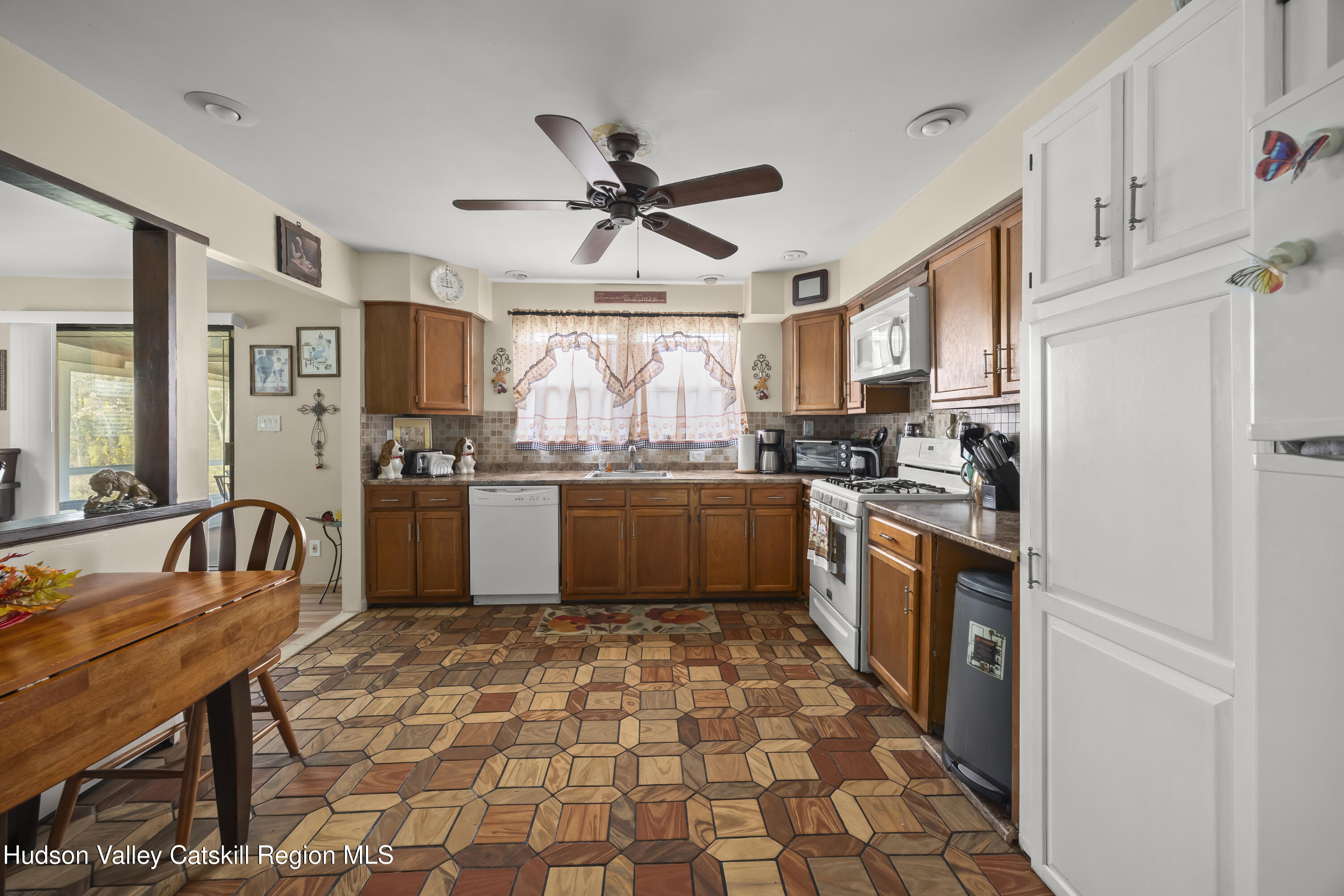 134 Willowbrook Road Hudson, NY 12534 - Photo 10 of 28 a kitchen with stainless steel appliances granite countertop a refrigerator a sink dishwasher a stove with wooden cabinets