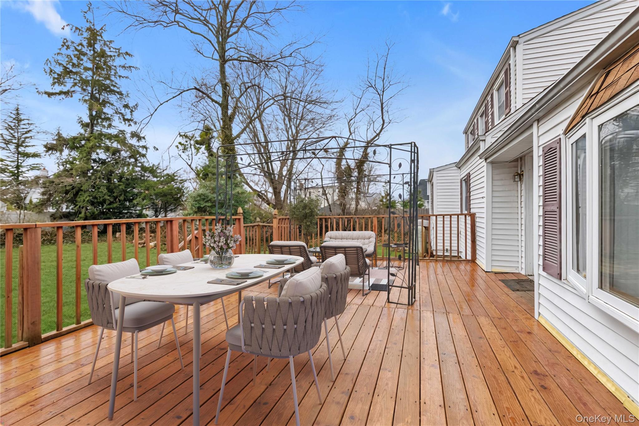 104 Vesper Court Babylon, NY 11702 - Photo 14 of 16 a view of a roof deck with table and chairs couches with wooden floor