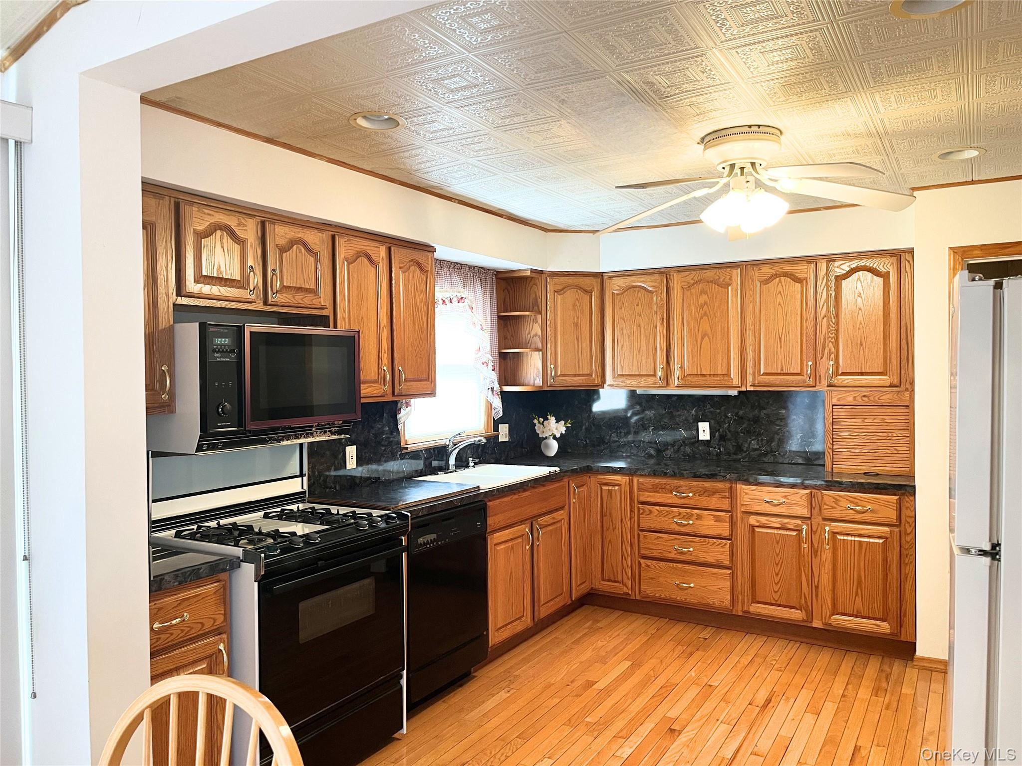 104 Vesper Court Babylon, NY 11702 - Photo 3 of 16 a kitchen with stainless steel appliances granite countertop a stove and a sink