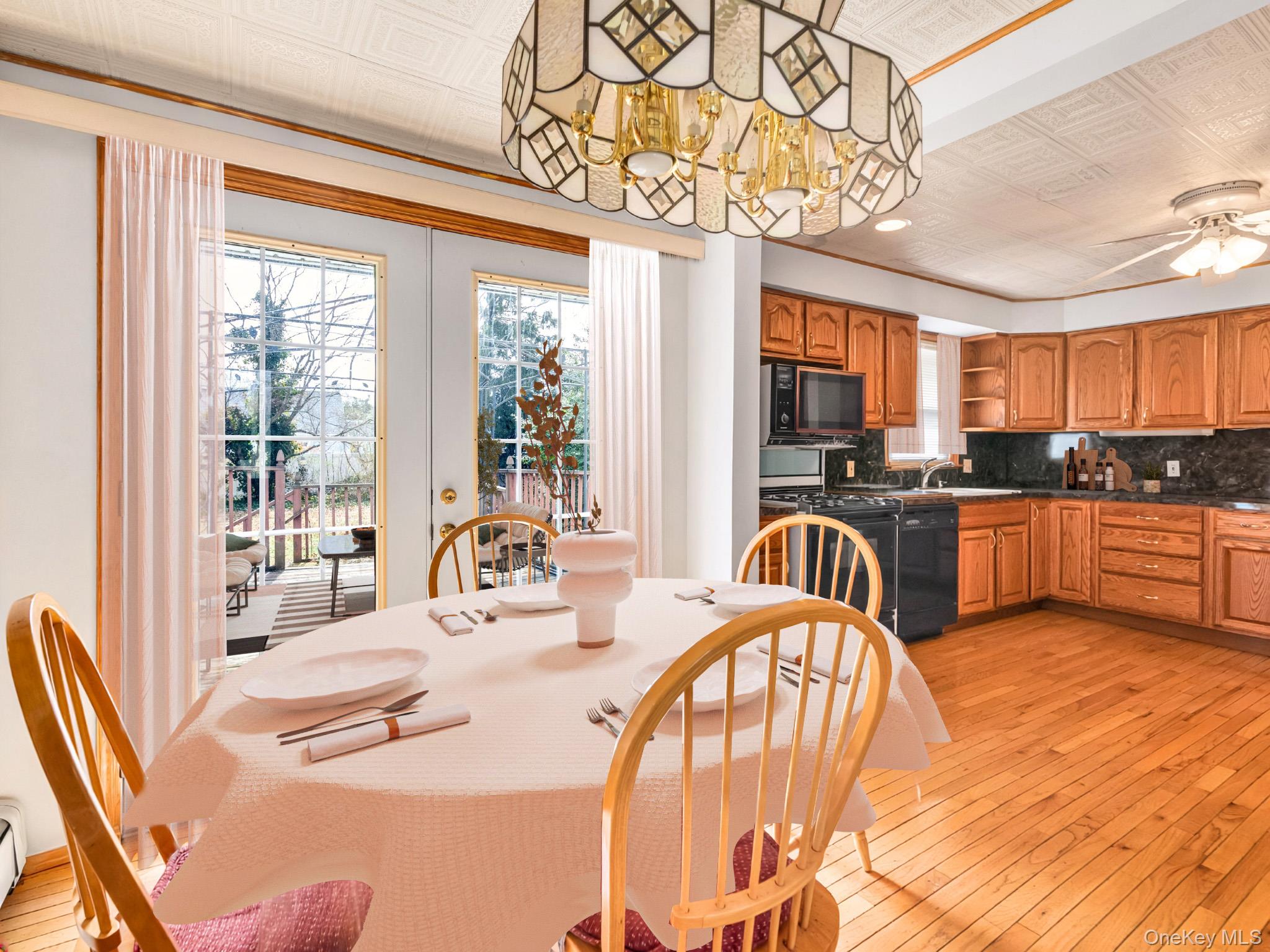 104 Vesper Court Babylon, NY 11702 - Photo 5 of 16 a kitchen with stainless steel appliances kitchen island granite countertop a stove a refrigerator a sink dishwasher with a dining table and chairs