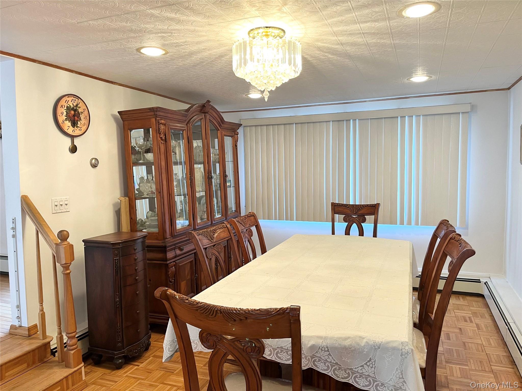 104 Vesper Court Babylon, NY 11702 - Photo 7 of 16 a view of a dining room with furniture and chandelier