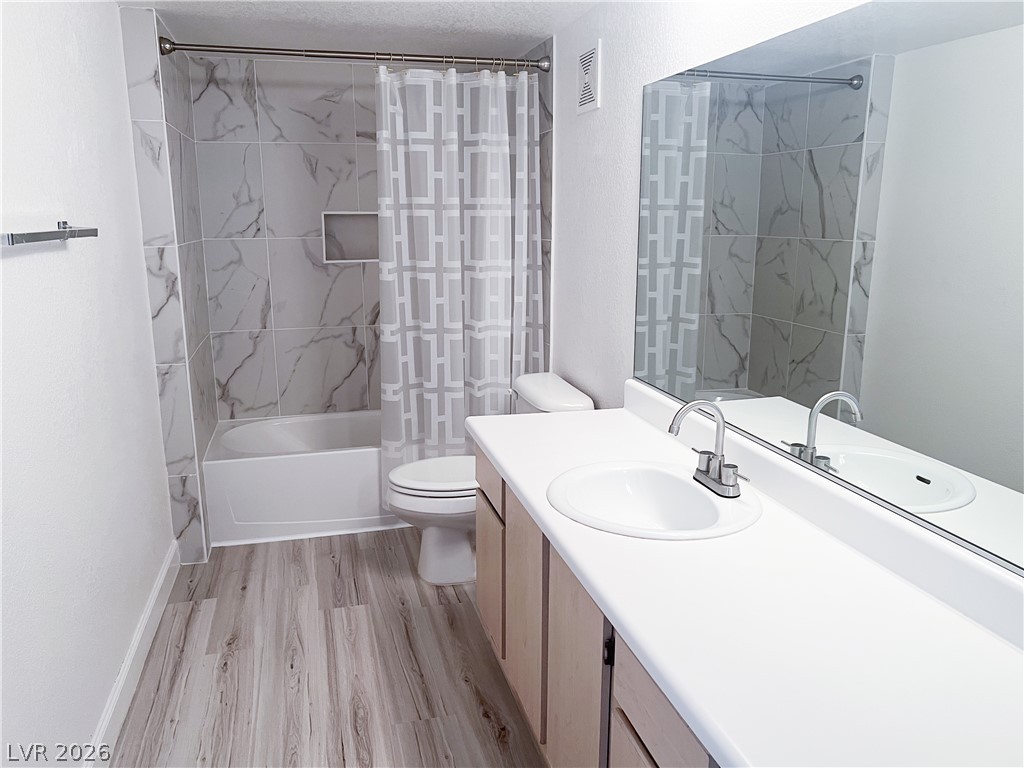 8101 West Flamingo Road, Unit 2129 Las Vegas, NV 89147 - Photo 9 of 12 A well-appointed bathroom features a full vanity with an integrated sink and an elegant tiled shower.