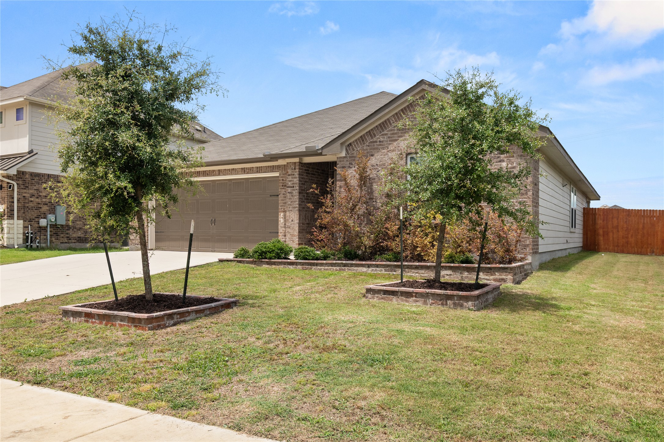 105 Saviano Road Hutto, TX 78634 - Photo 2 of 22 A welcoming brick exterior provides enduring curb appeal for this charming single-story residence.