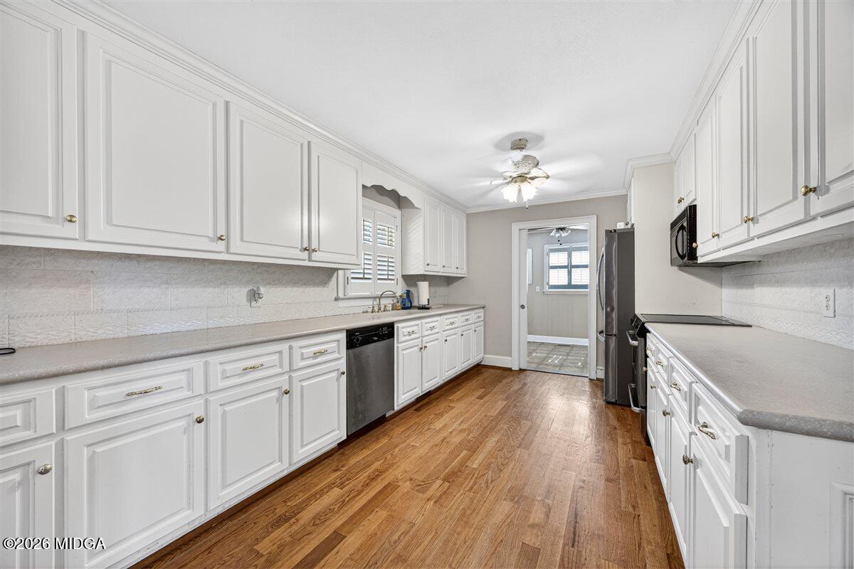 335 Hamrick Road Macon, GA 31220 - Photo 4 of 41 a kitchen with granite countertop white cabinets and white appliances