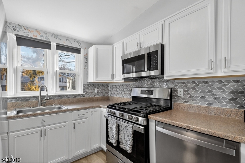 348 Broad Street Mount Holly, NJ 08060 - Photo 13 of 30 a kitchen with granite countertop white cabinets stainless steel appliances and a sink