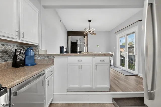 a bathroom with a granite countertop sink and a toilet