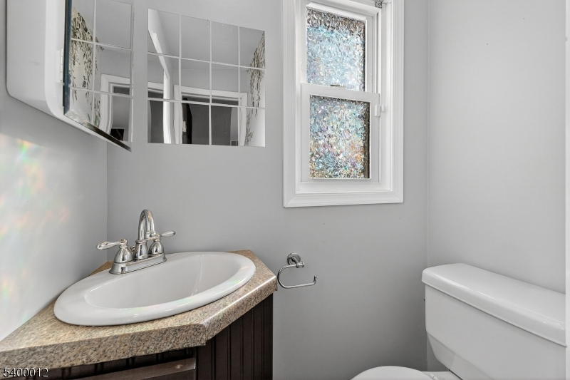 348 Broad Street Mount Holly, NJ 08060 - Photo 15 of 30 a bathroom with a granite countertop sink and a toilet