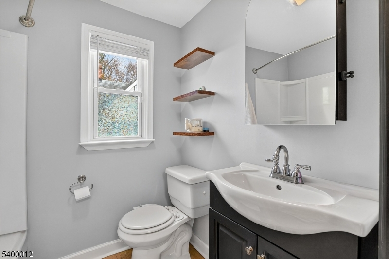 348 Broad Street Mount Holly, NJ 08060 - Photo 22 of 30 a bathroom with a sink toilet and a mirror