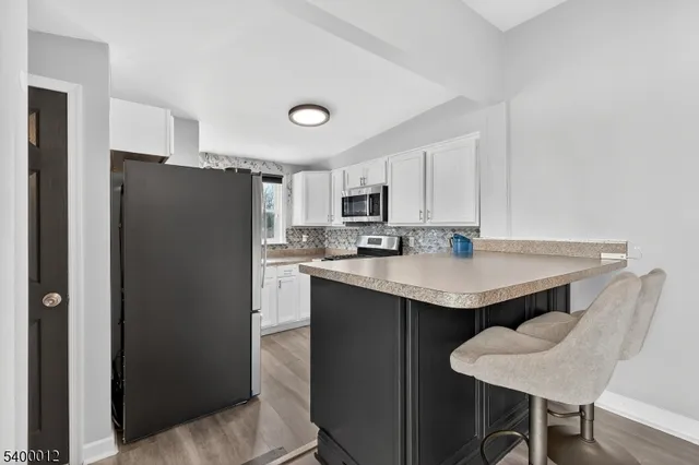 a kitchen with stainless steel appliances kitchen island a cabinets and a stove top oven