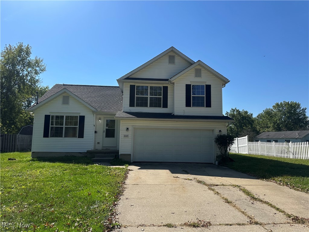9137 Maple Grove Road Windham, OH 44288 - Photo 1 of 17 Traditional-style home with an attached garage and concrete driveway