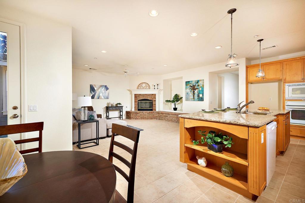 293 Star Jasmine Lane Encinitas, CA 92024 - Photo 20 of 37 a living room with furniture a rug and kitchen chandelier