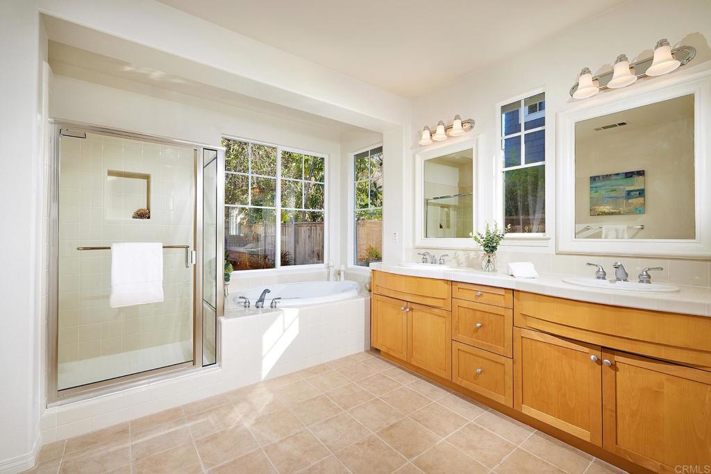 293 Star Jasmine Lane Encinitas, CA 92024 - Photo 29 of 37 a spacious bathroom with a tub sink and mirror