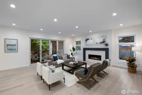 a living room with furniture fireplace and window