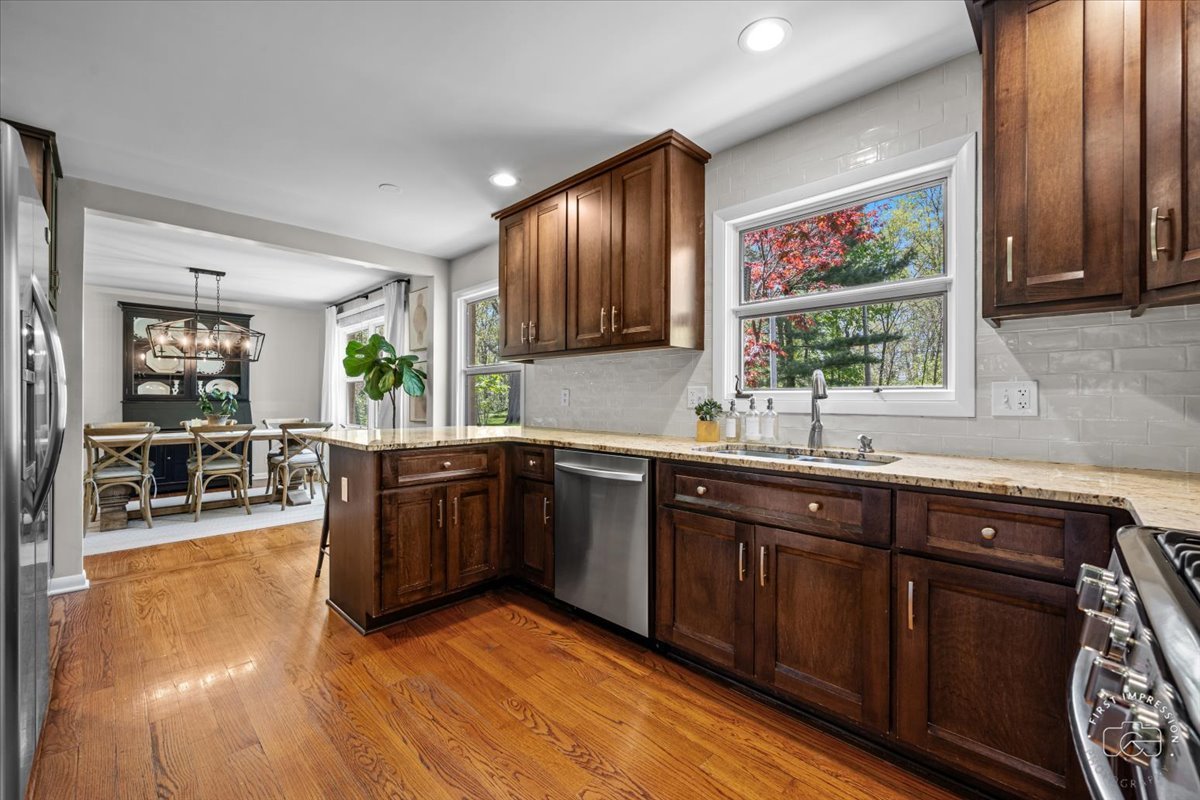 1508 Dunstan Road Geneva, IL 60134 - Photo 11 of 30 a kitchen with stainless steel appliances granite countertop wooden cabinets a sink and dishwasher