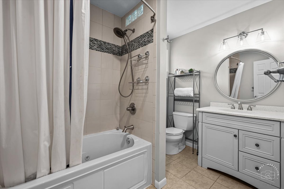 1508 Dunstan Road Geneva, IL 60134 - Photo 23 of 30 a bathroom with a double vanity sink toilet mirror and bathtub