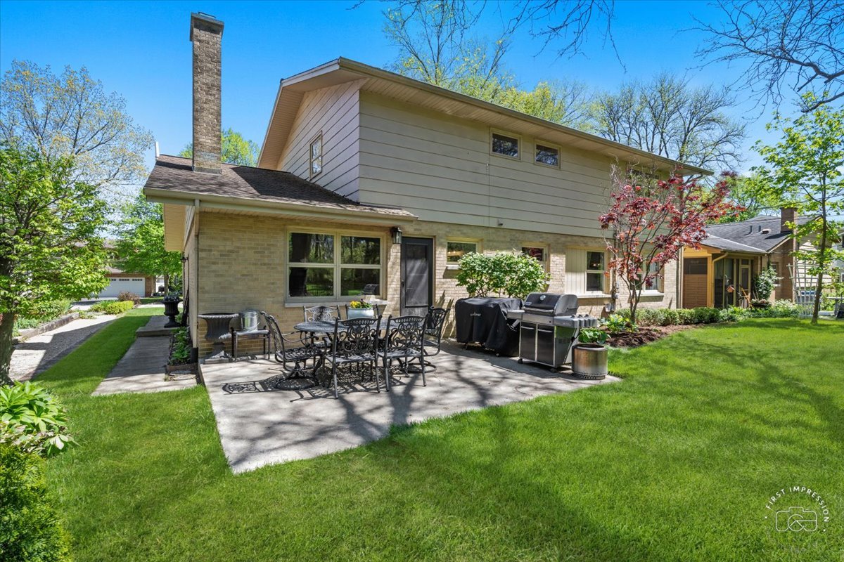 1508 Dunstan Road Geneva, IL 60134 - Photo 26 of 30 a view of backyard of house with outdoor seating and green space