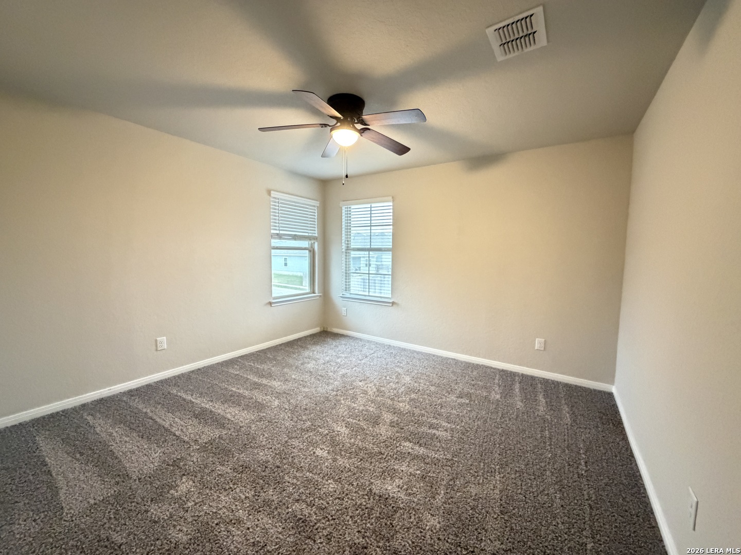 6814 Shiraz Way Converse, TX 78109 - Photo 11 of 16 an empty room with windows and fan