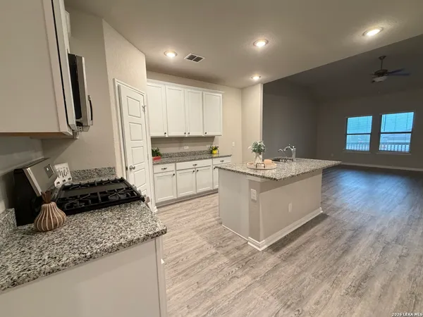 a kitchen with a sink stove and cabinets