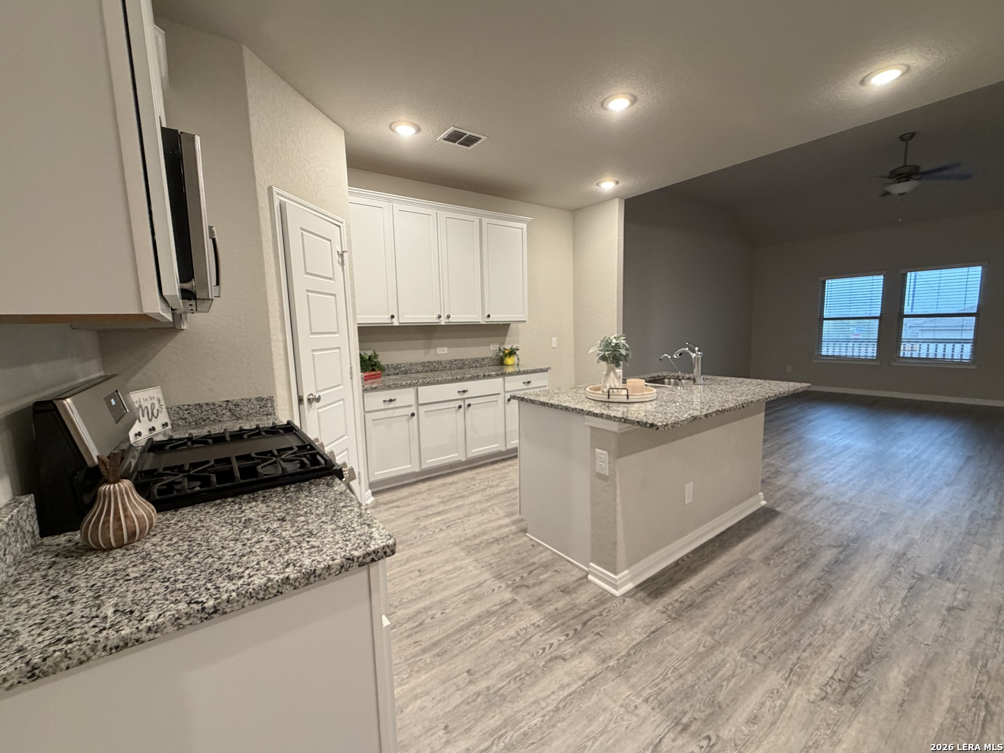 6814 Shiraz Way Converse, TX 78109 - Photo 2 of 16 a kitchen with a sink stove and cabinets