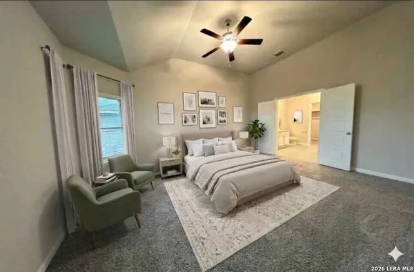 a spacious bedroom with a bed couch and a window