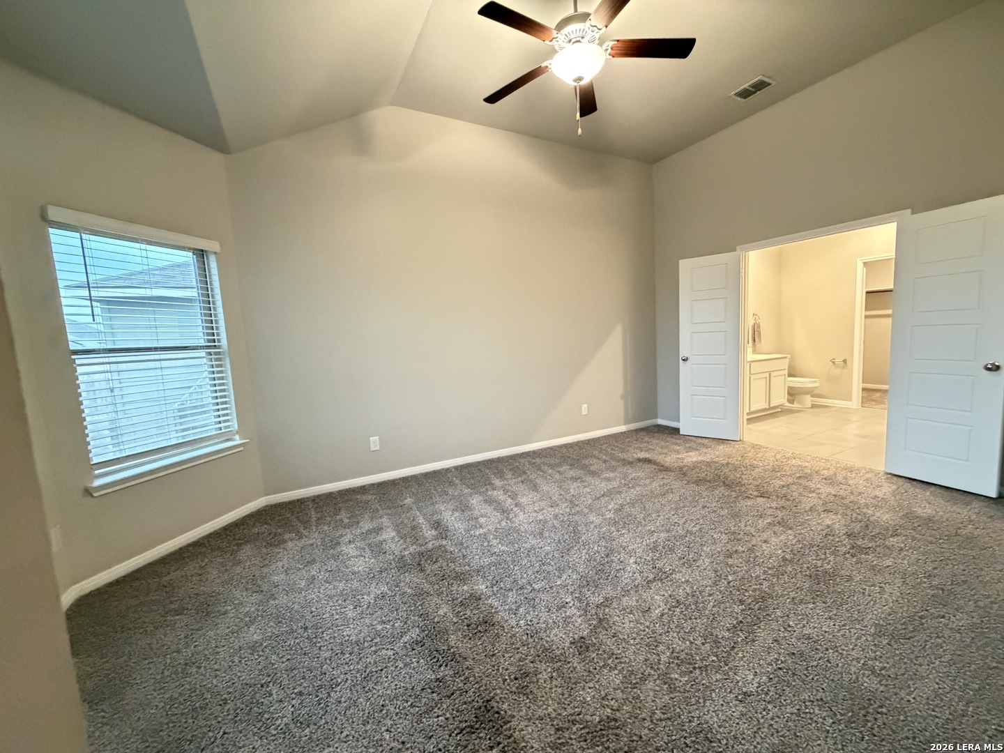 6814 Shiraz Way Converse, TX 78109 - Photo 6 of 16 an empty room with chandelier fan and windows
