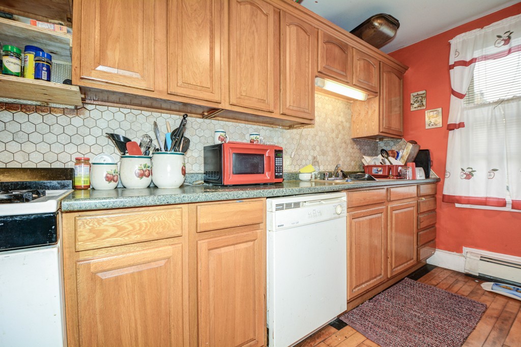 31 Ripley Street Worcester, MA 01610 - Photo 11 of 16 a kitchen with stainless steel appliances granite countertop a sink stove and cabinets