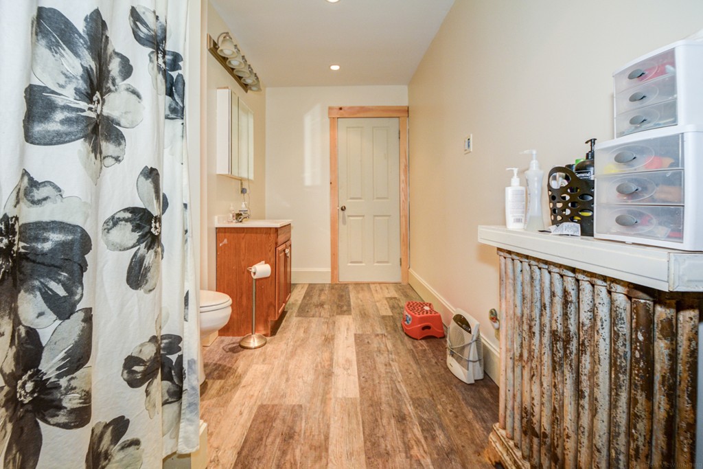 31 Ripley Street Worcester, MA 01610 - Photo 6 of 16 a view of a hallway with wooden floor and front door