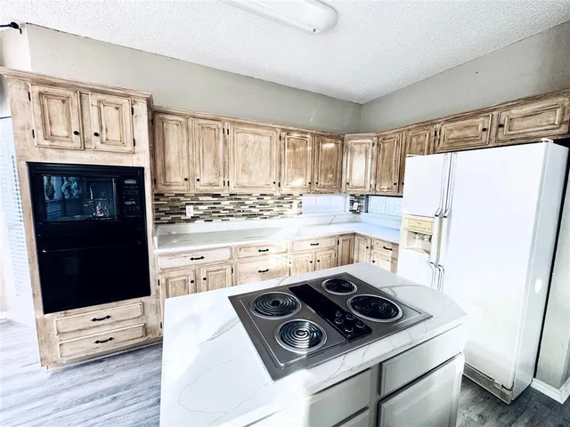 a kitchen with a stove and a refrigerator