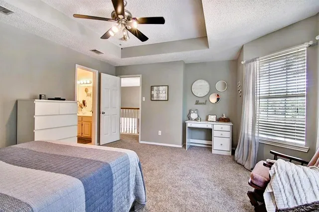 a spacious bedroom with a bed and a large window