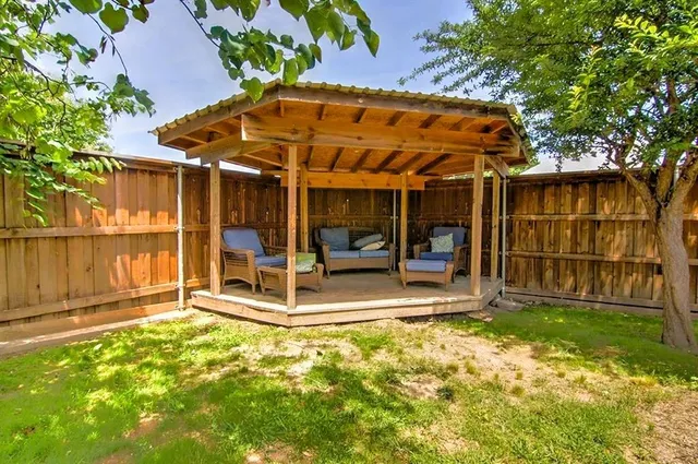 a view of a yard with a house and a street