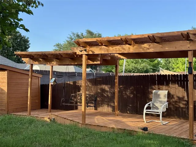 a view of a backyard with a small cabin and a chair