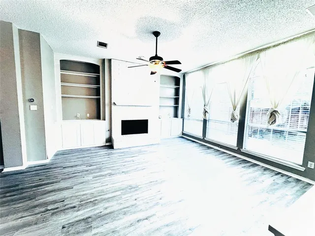 a view of a kitchen with a sink and a refrigerator