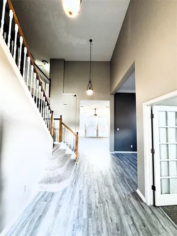 a view of entryway and hall with wooden floor