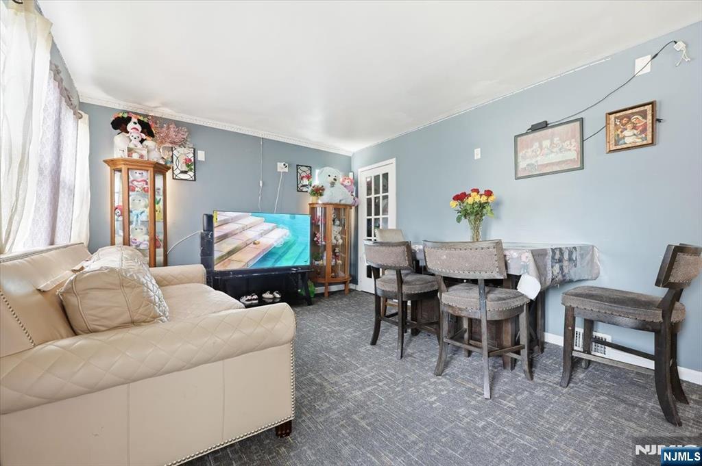 409 Tryon Avenue Englewood, NJ 07631 - Photo 4 of 33 a living room with furniture and a flat screen tv