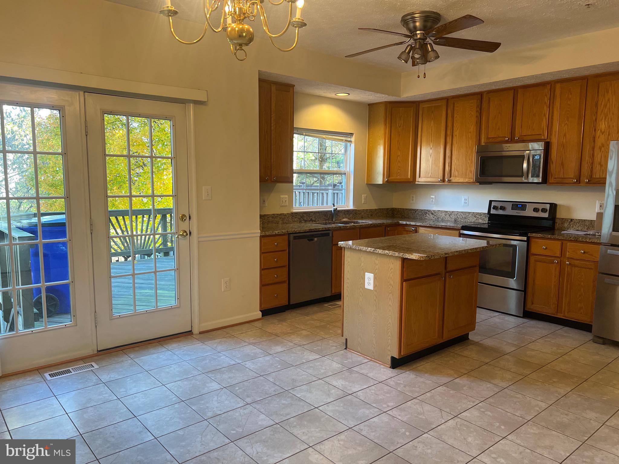 9526 Bellhaven Court Frederick, MD 21701 - Photo 2 of 23 a kitchen with stainless steel appliances granite countertop a stove a sink dishwasher a refrigerator and a microwave