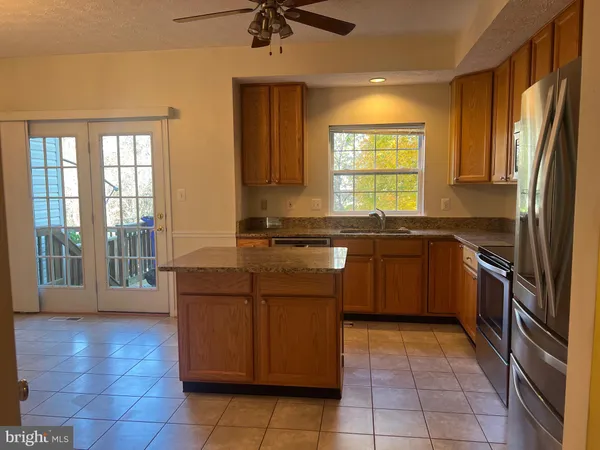 a kitchen with a sink counter top space appliances and a window