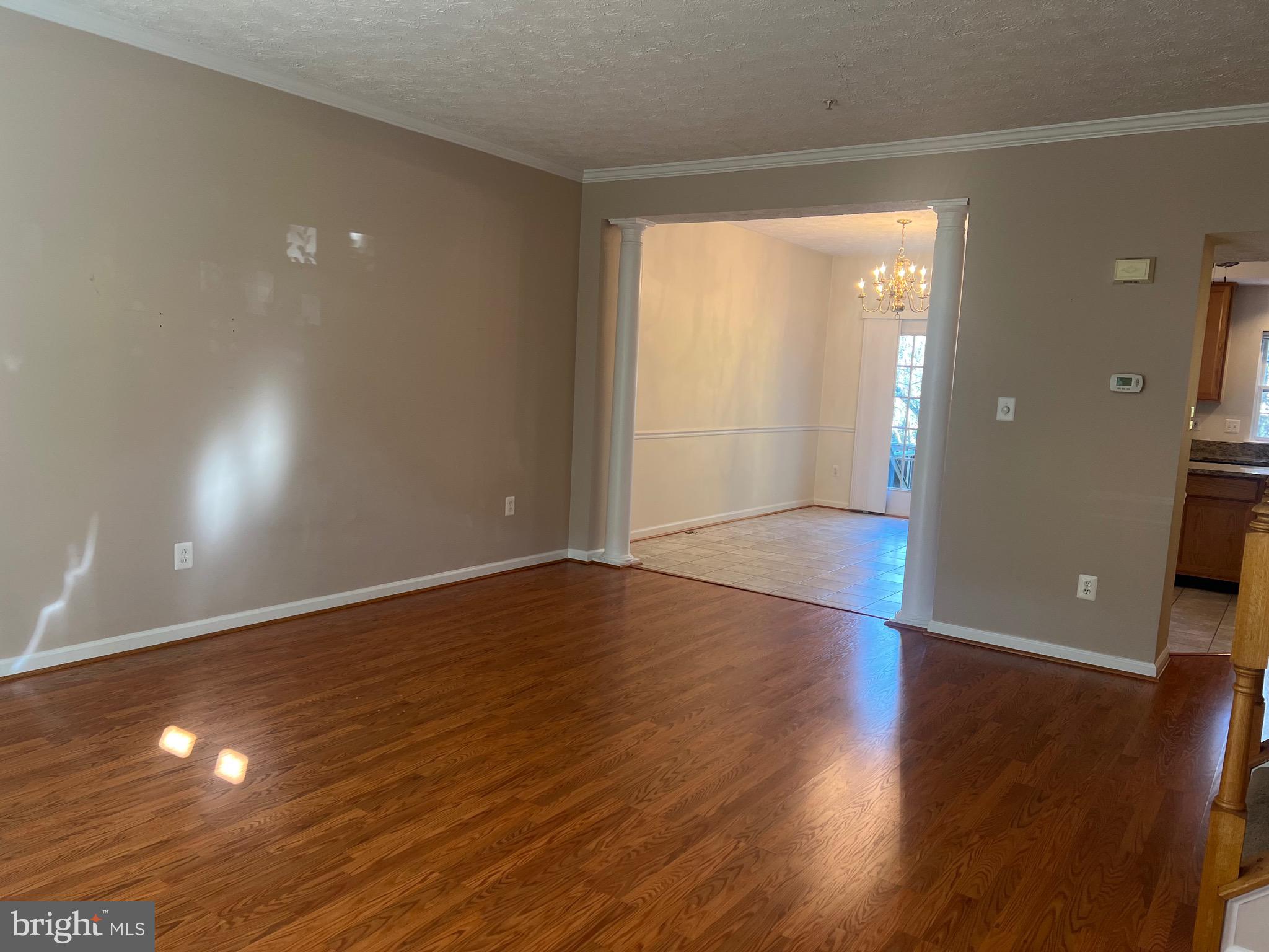 9526 Bellhaven Court Frederick, MD 21701 - Photo 5 of 23 a view of an empty room with wooden floor and a window