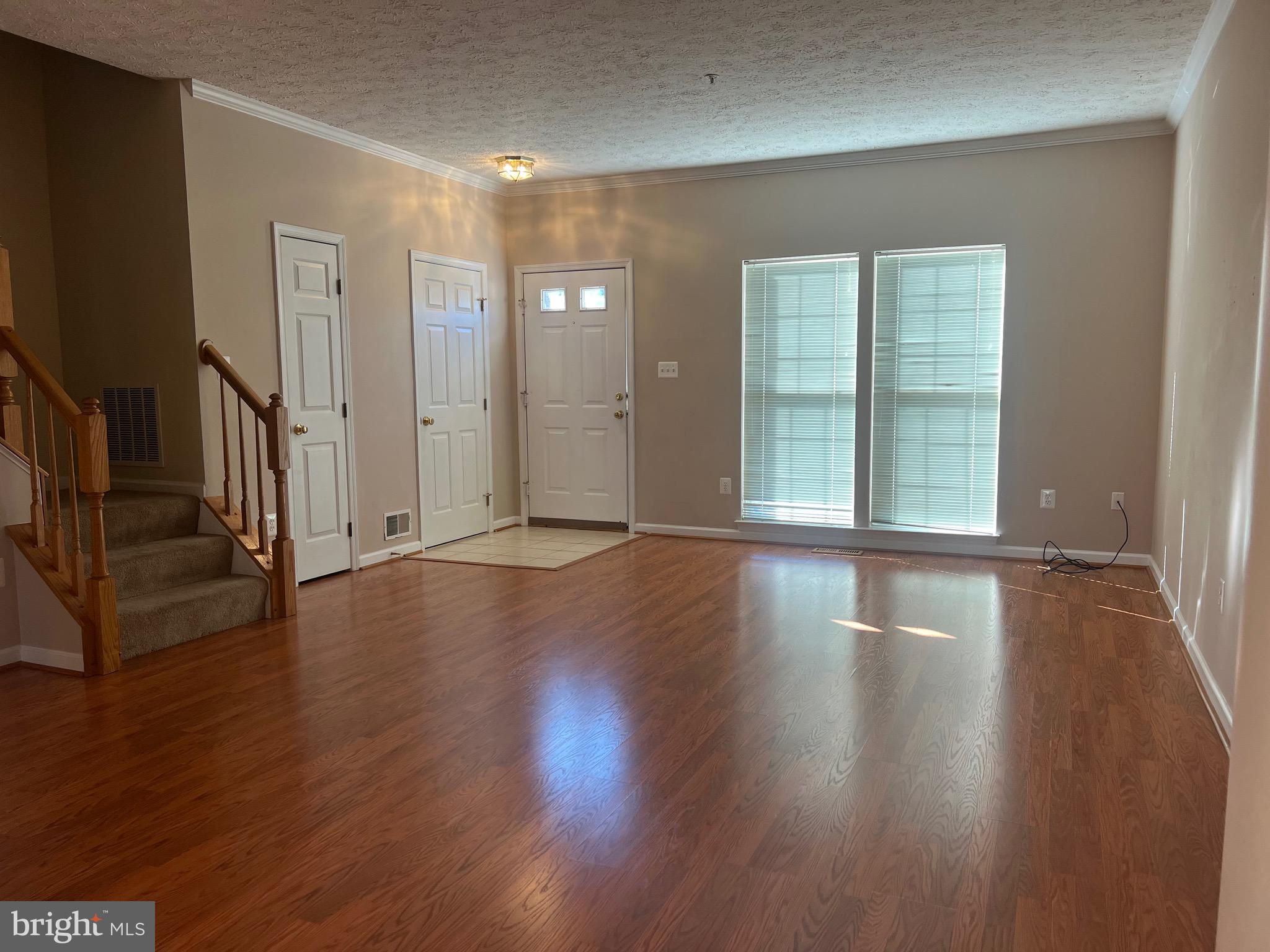 9526 Bellhaven Court Frederick, MD 21701 - Photo 6 of 23 an empty room with wooden floor and windows