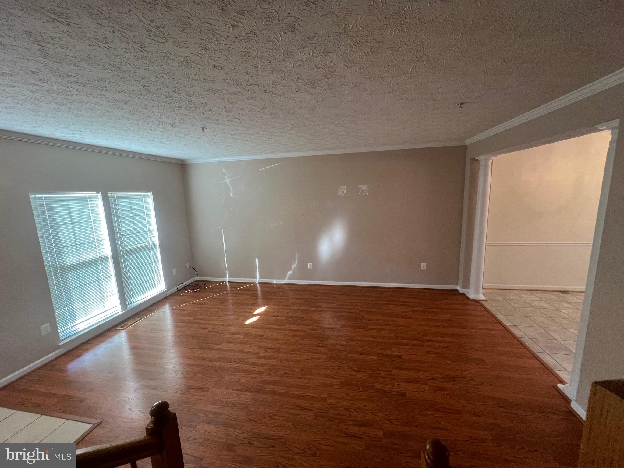 9526 Bellhaven Court Frederick, MD 21701 - Photo 8 of 23 a view of an empty room with wooden floor and a window