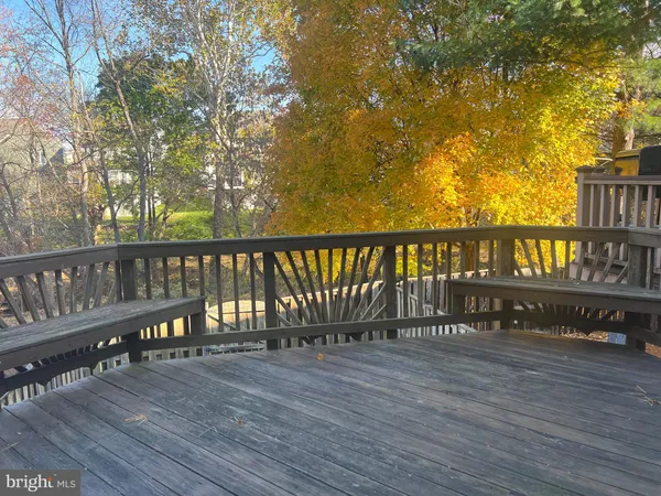 a balcony with wooden floor and fence