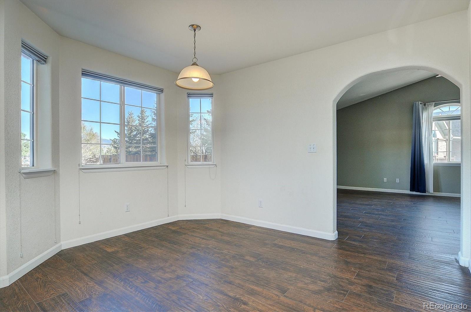 160 Windwalker Road Buena Vista, CO 81211 - Photo 19 of 47 an empty room with wooden floor and windows