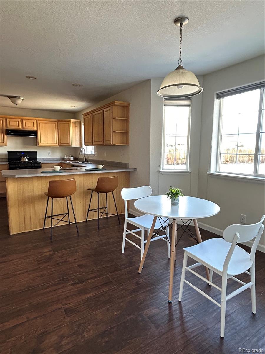 160 Windwalker Road Buena Vista, CO 81211 - Photo 20 of 47 a dining room with furniture a chandelier and wooden floor