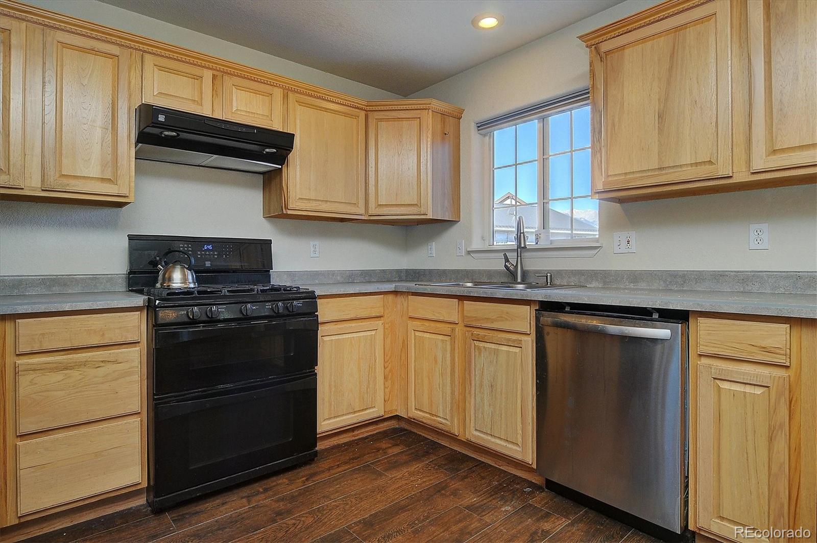 160 Windwalker Road Buena Vista, CO 81211 - Photo 22 of 47 a kitchen with granite countertop wooden cabinets and a stove