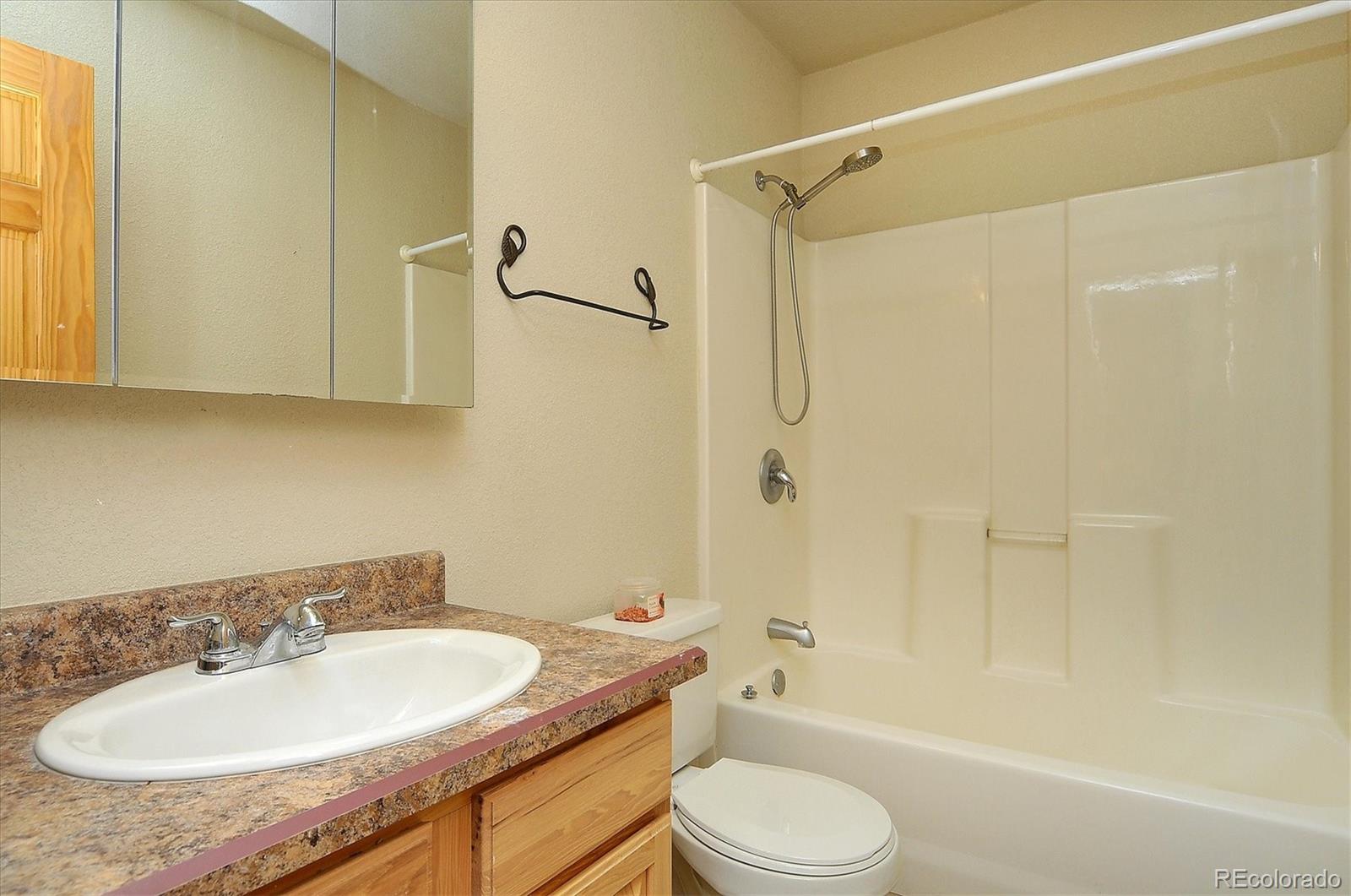 160 Windwalker Road Buena Vista, CO 81211 - Photo 33 of 47 a bathroom with a granite countertop sink toilet and shower