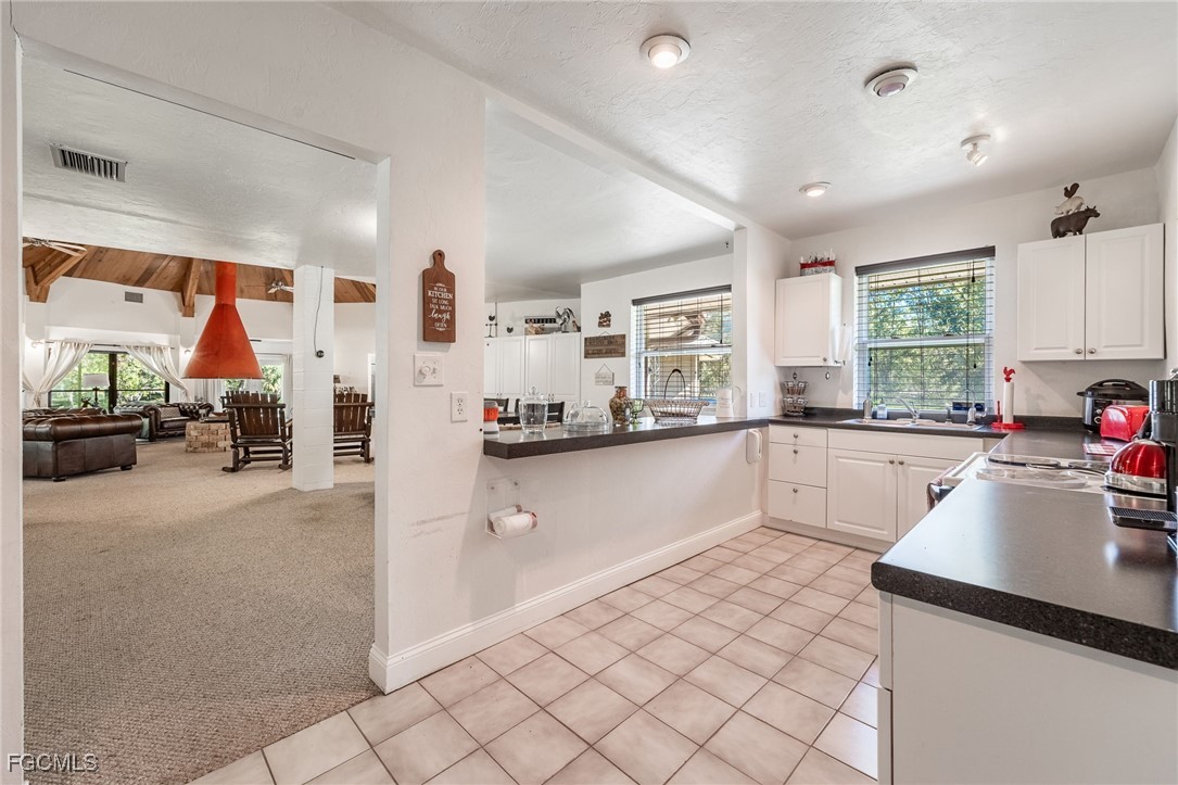 1400 Catamount Road LaBelle, FL 33935 - Photo 21 of 50 a kitchen with stainless steel appliances granite countertop a refrigerator and a sink