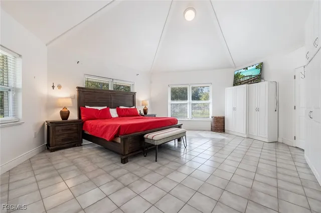 a spacious bedroom with a bed and window